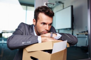 Businessman fired from work sitting sad at office